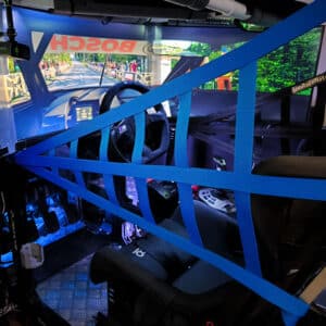 Blue sim racing safety net mounted on the side of a cockpit