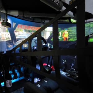 Black sim racing safety net mounted on the side of a cockpit